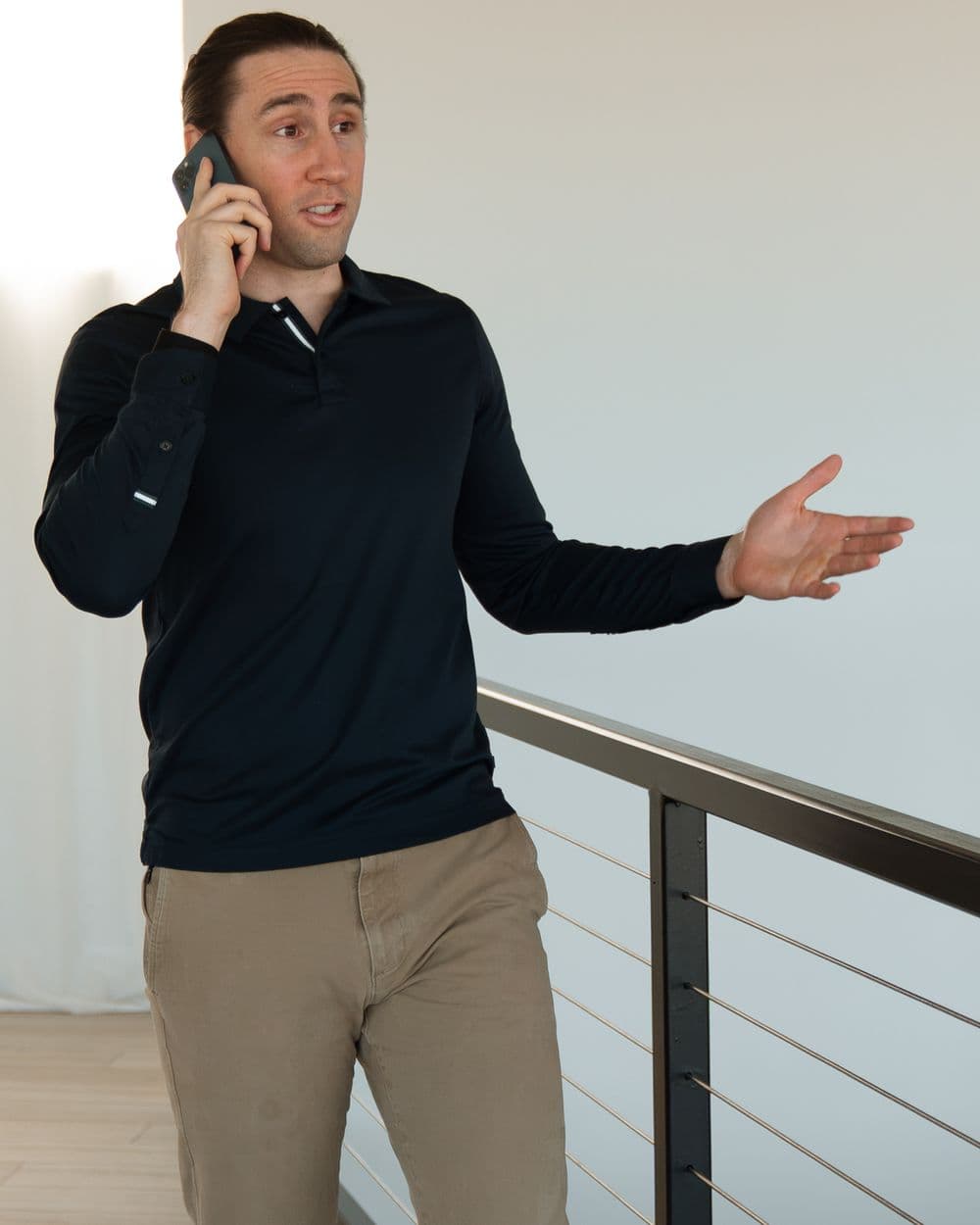 Colin Zaccagnio talking on the phone with a client while walking through a listing